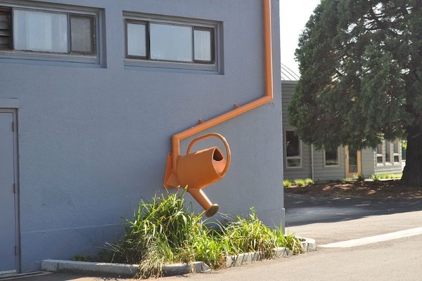 a water can attached to a downspout