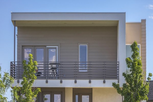 flat roofed home with elegant balcony